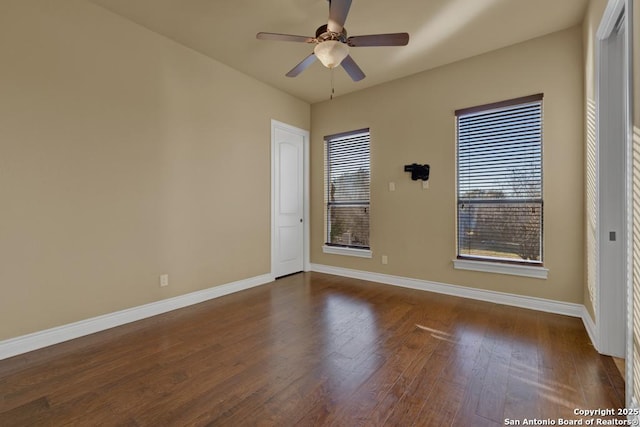 unfurnished room with ceiling fan and dark hardwood / wood-style floors