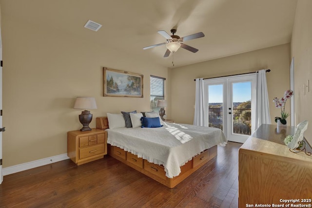 bedroom featuring french doors, dark hardwood / wood-style floors, multiple windows, and access to outside