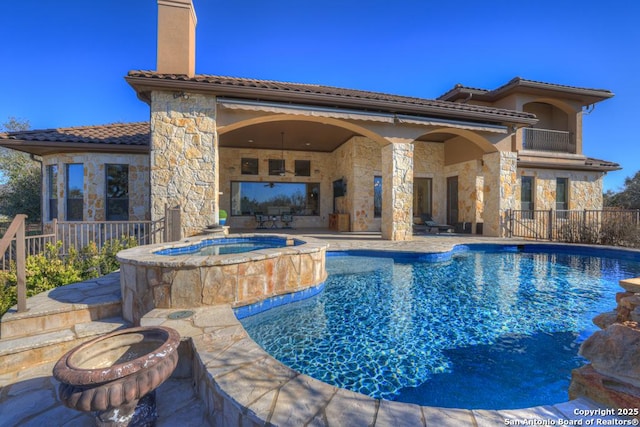 view of swimming pool with an in ground hot tub and a patio area