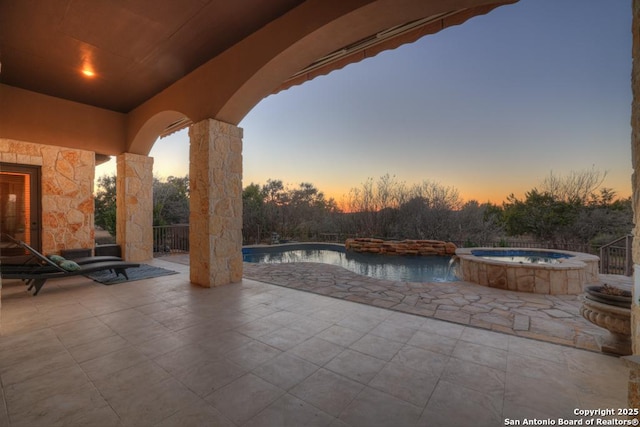 exterior space featuring a pool with hot tub