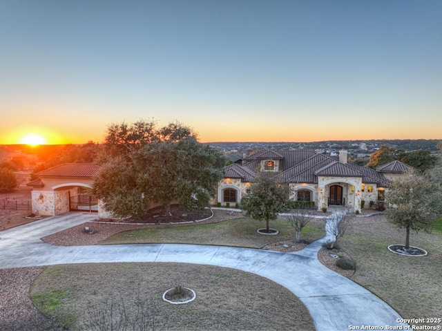 mediterranean / spanish-style house featuring a lawn