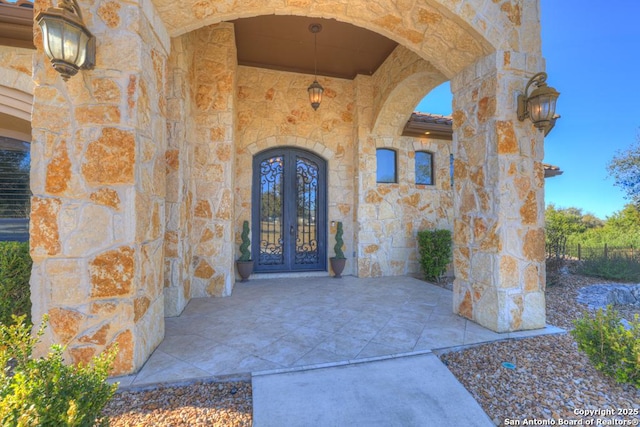 entrance to property with a patio area and french doors