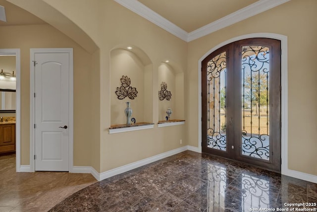 foyer featuring french doors and crown molding