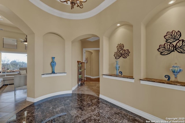 interior space featuring ornamental molding and a notable chandelier