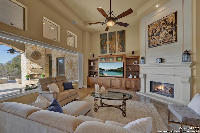 living room with a high ceiling and ceiling fan