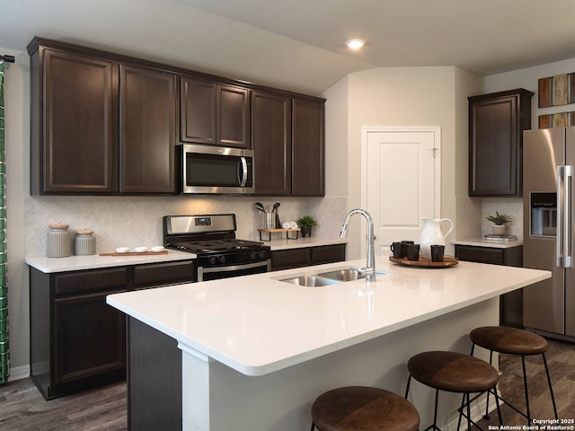 kitchen featuring appliances with stainless steel finishes, sink, and a center island with sink