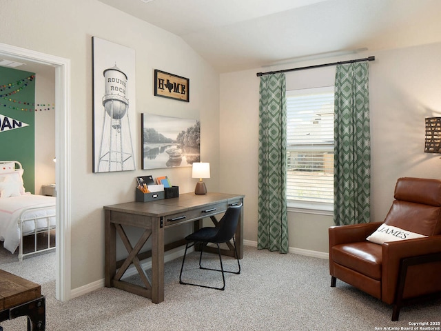 office area featuring lofted ceiling and light colored carpet