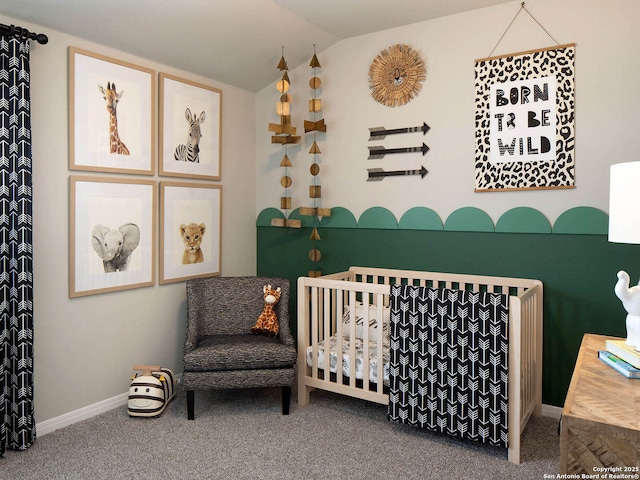 bedroom with lofted ceiling, carpet floors, and a nursery area