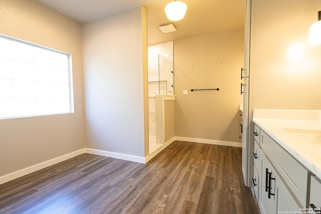 bathroom with a shower, wood-type flooring, and vanity