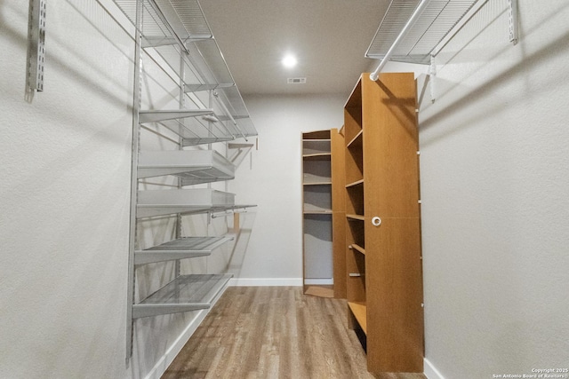 walk in closet featuring hardwood / wood-style flooring