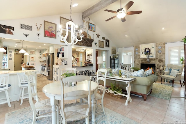 dining room with light tile patterned floors, high vaulted ceiling, a fireplace, ceiling fan with notable chandelier, and beamed ceiling