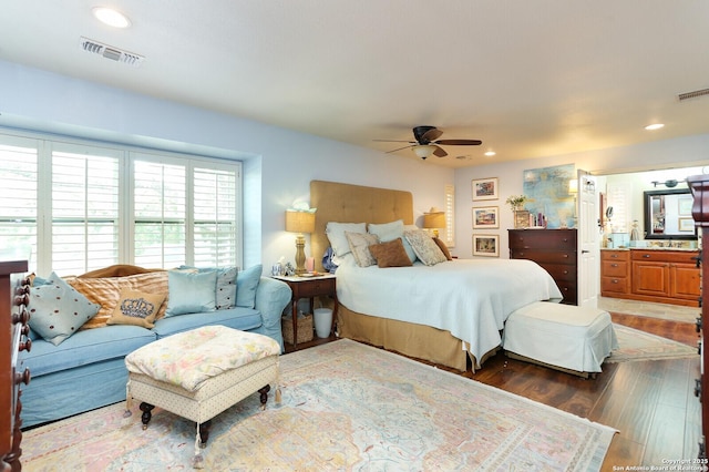 bedroom with dark hardwood / wood-style floors, ceiling fan, and ensuite bathroom