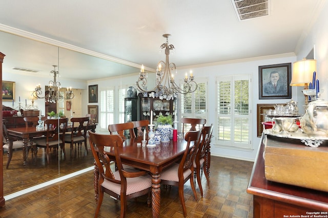 dining room with dark parquet flooring, plenty of natural light, and an inviting chandelier