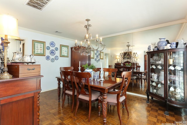 dining room featuring crown molding, dark parquet flooring, and a notable chandelier