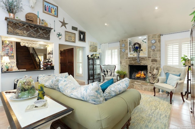 living room featuring light tile patterned floors, a fireplace, and high vaulted ceiling