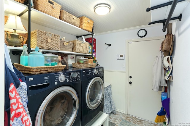 laundry area featuring crown molding and washing machine and dryer