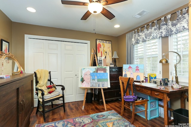 home office with dark wood-type flooring and ceiling fan