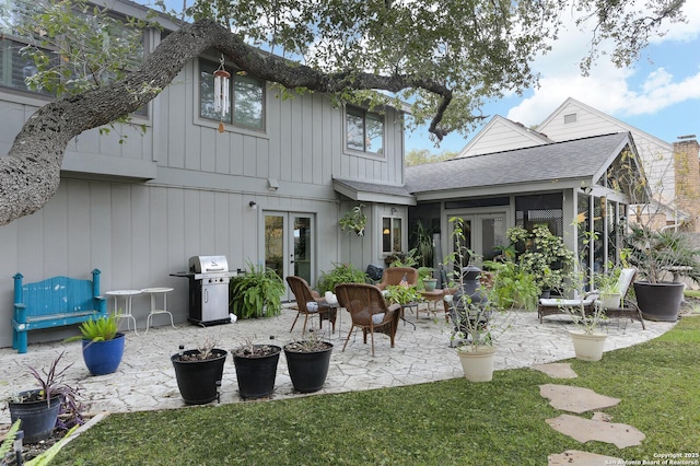 rear view of property with a lawn and a patio area