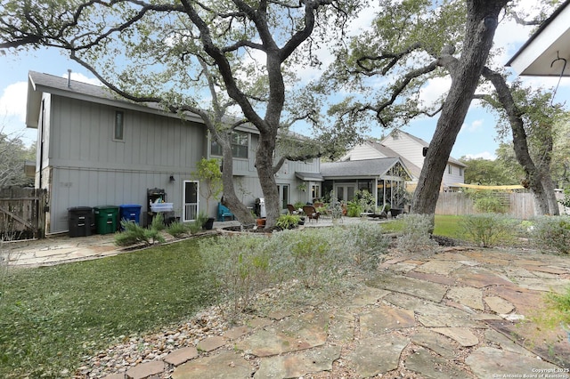 rear view of property with a patio area and a lawn