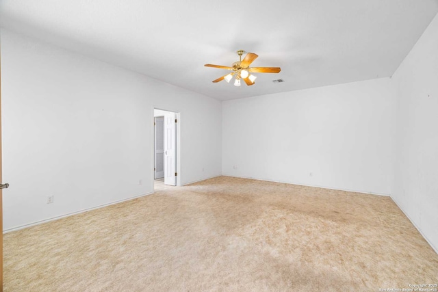 empty room with ceiling fan and light carpet