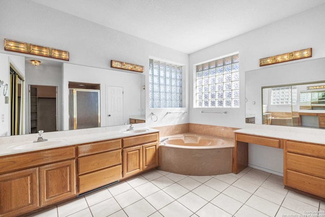 bathroom with vanity, tile patterned floors, and plus walk in shower