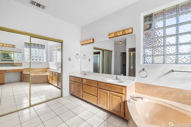 bathroom featuring vanity, shower with separate bathtub, and tile patterned floors