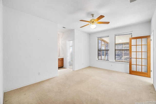 unfurnished room featuring light carpet and ceiling fan