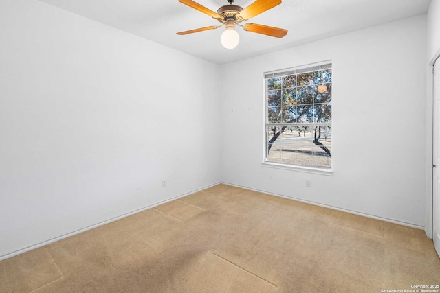 unfurnished room featuring ceiling fan and carpet