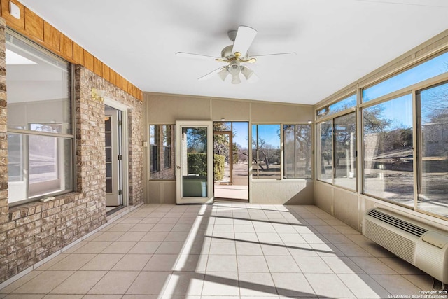 unfurnished sunroom with ceiling fan