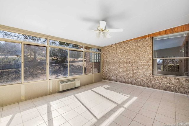 unfurnished sunroom featuring a wall mounted AC and ceiling fan