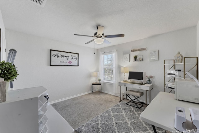 carpeted office with ceiling fan and a textured ceiling