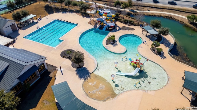 view of swimming pool featuring a water slide and a patio area