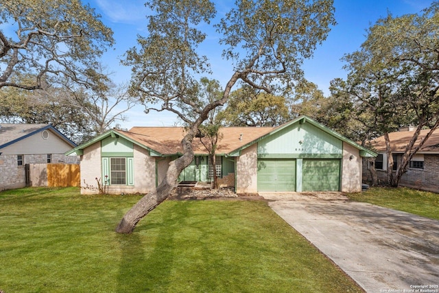 single story home featuring a garage and a front lawn