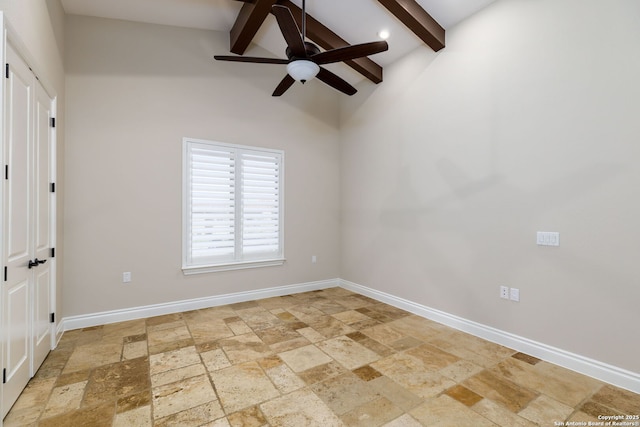 spare room with vaulted ceiling with beams and ceiling fan