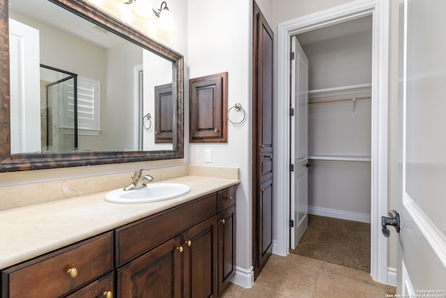 bathroom with tile patterned floors, vanity, and a shower