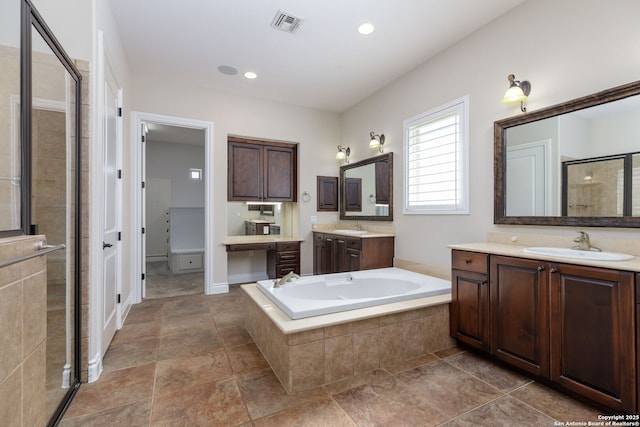 bathroom featuring vanity and shower with separate bathtub