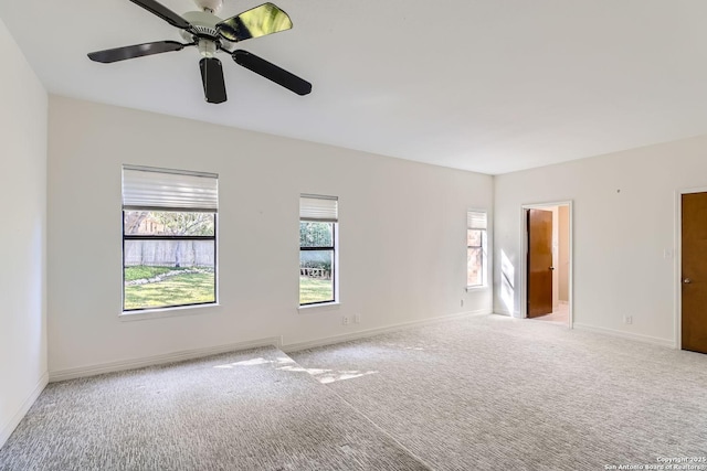 spare room with ceiling fan and light carpet