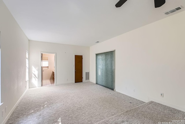 unfurnished room featuring light carpet and ceiling fan