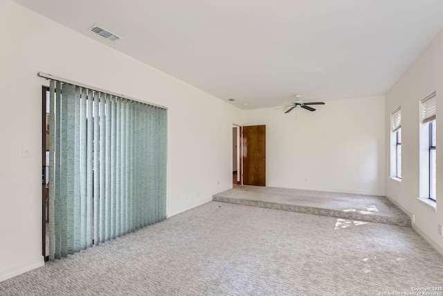 carpeted spare room featuring ceiling fan