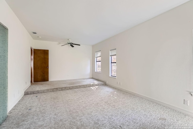 unfurnished room with ceiling fan and carpet flooring