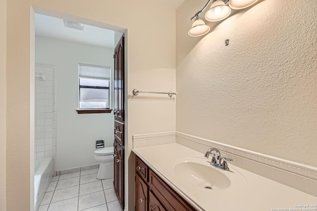 bathroom with tile patterned flooring, vanity, and toilet