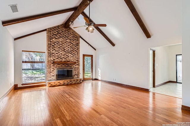 unfurnished living room with ceiling fan, a fireplace, high vaulted ceiling, and light hardwood / wood-style flooring