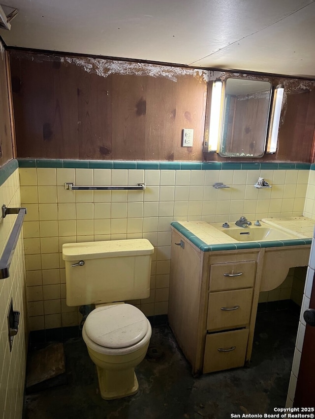 bathroom with toilet and tile walls