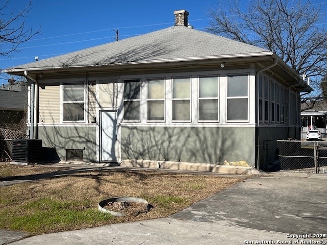 view of side of home featuring central AC unit