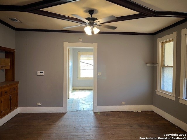 unfurnished dining area with dark hardwood / wood-style flooring, ornamental molding, and ceiling fan