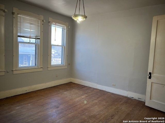 spare room with dark hardwood / wood-style floors