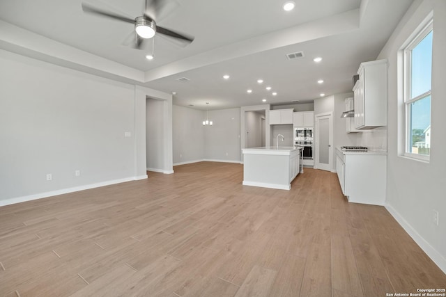 211 Ryan Xing, San Antonio, TX 78253 - unfurnished living room with light wood finished floors, ceiling fan, plenty of natural light, baseboards, and recessed lighting