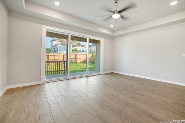 211 Ryan Xing, San Antonio, TX 78253 - empty room with wood finished floors, a raised ceiling, baseboards, and recessed lighting