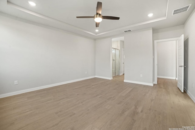 211 Ryan Xing, San Antonio, TX 78253 - unfurnished bedroom featuring a tray ceiling, recessed lighting, baseboards, light wood-type flooring, and ceiling fan