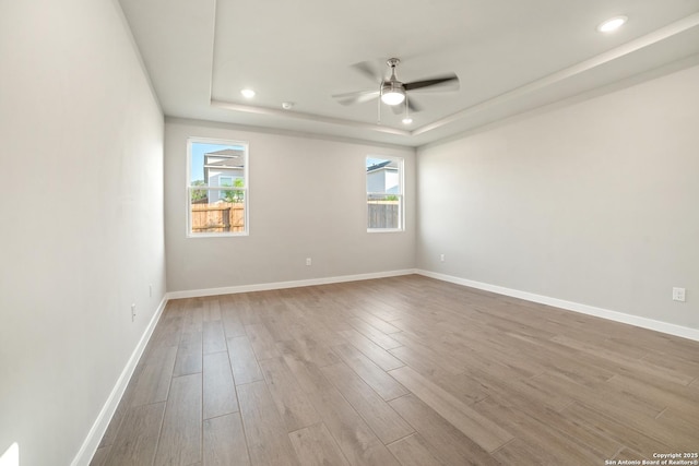 211 Ryan Xing, San Antonio, TX 78253 - unfurnished room with wood finished floors, a raised ceiling, ceiling fan, baseboards, and recessed lighting